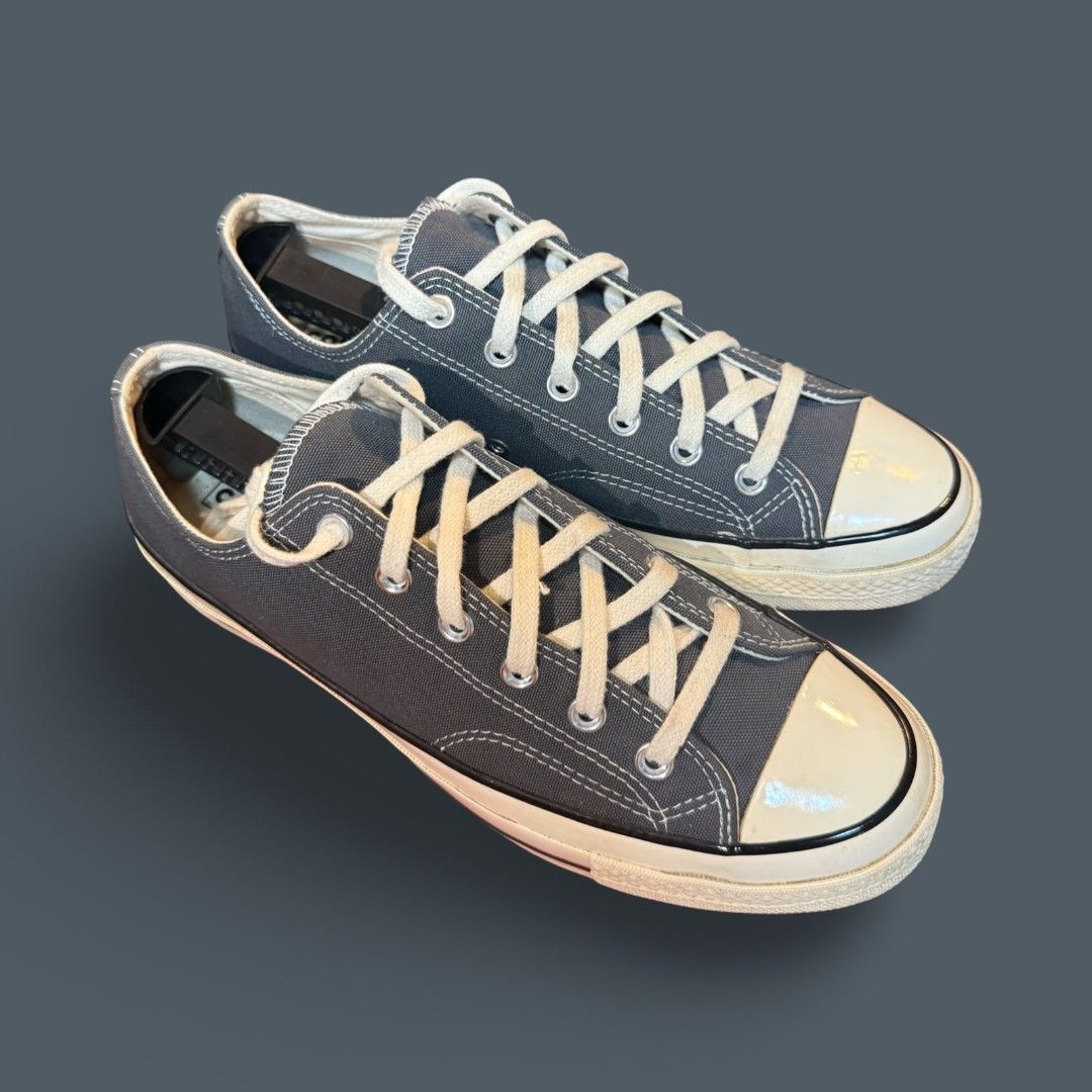 Converse Chuck 70 Low Dark Grey (Category: Casual Shoes) located in Del Monte. Submitted by jasonjuan31 (Listing ID 1466498069, Image 3). Description: - Brand: Converse Chuck 70 Low Top - Color: Dark grey canvas with contrast stitching and cream laces - Details: Classic white rubber toe caps, glossy foxing tape, metal eyelets, and black heel license plate - Condition: Well-maintained, always kept with shoe trees to preserve shape - Style: Versati
