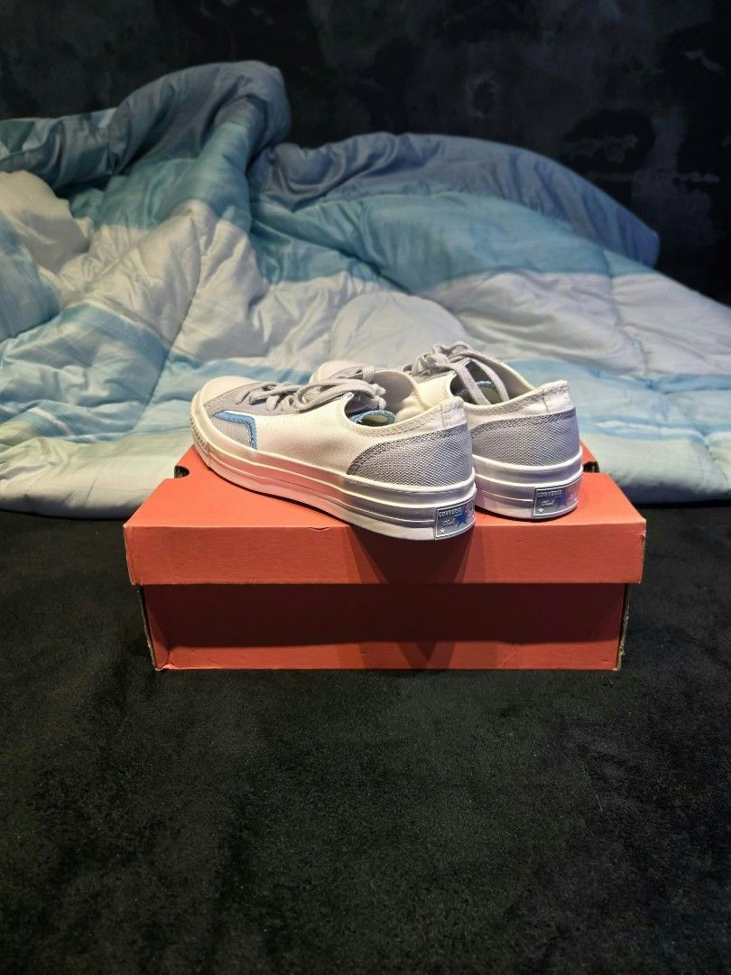 Converse Chuck 70 Low Grey White Blue (Category: Sneakers) located in Indang. Submitted by yoowhann (Listing ID 1466385914, Image 2). Description: - Brand: Converse - Style: Low-top sneakers - Color: Grey and white with light blue contrast stitching - Features: Rubber toe cap, flat laces, textured midsoles - Condition: Clean uppers and pristine outsoles - Packaging: Original orange shoe box included.