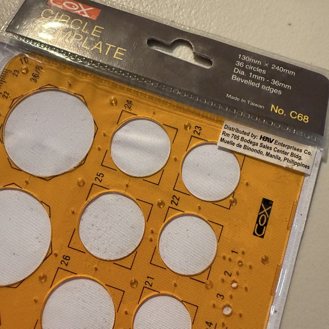 Cox Circle Template No. C68 (Category: Craft Supplies & Tools) located in Manila. Submitted by cheemkenn (Listing ID 1466413679, Image 2). Description: - Brand: Cox - Model: C68 Circle Template Tool - Condition: Brand new, still sealed in original packaging - Dimensions: 130mm x 240mm - Features: 36 circles with diameters from 1mm to 36mm - Design: Beveled edges for precise drawing made of clear yellow plastic.