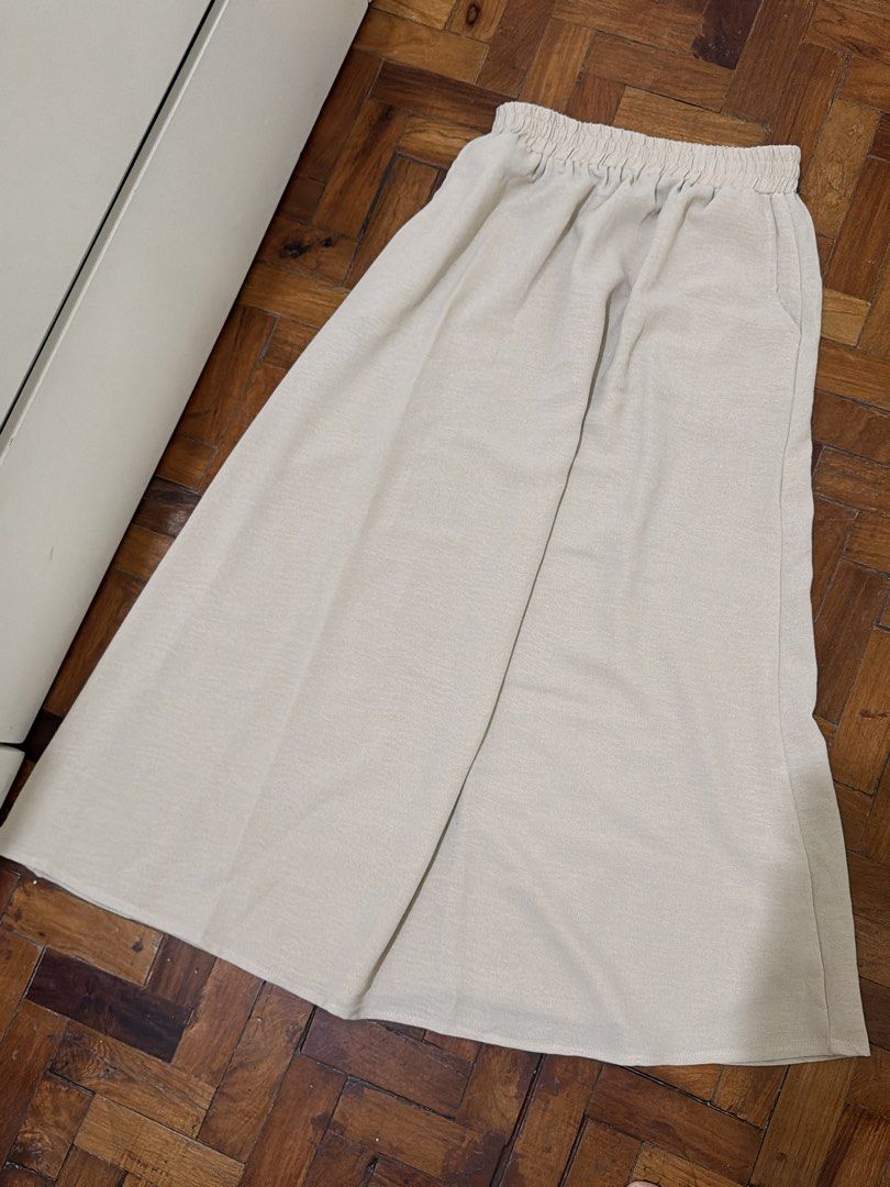 Cream beige skirt (Category: Skirts) located in Manila. Submitted by wearagainfinds (Listing ID 1466405801, Image 1). Description: - Color: Cream beige - Fit: Relaxed wide leg with a comfortable elastic waistband - Fabric: Lightweight with a gorgeous, flowing drape - Style: Versatile and easy to pair with any basic top.