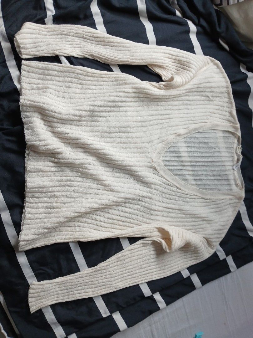 Cream Ribbed V-Neck Mesh Long Sleeve (Category: Longsleeves) located in Manila. Submitted by relaxlang (Listing ID 1466391732, Image 2). Description: - Color: Cream - Style: Long sleeve pullover with deep V-neckline - Texture: Vertical ribbed knit throughout body and sleeves - Material: Lightweight and easy to layer - Versatility: Neutral shade that pairs well with denim or skirts.