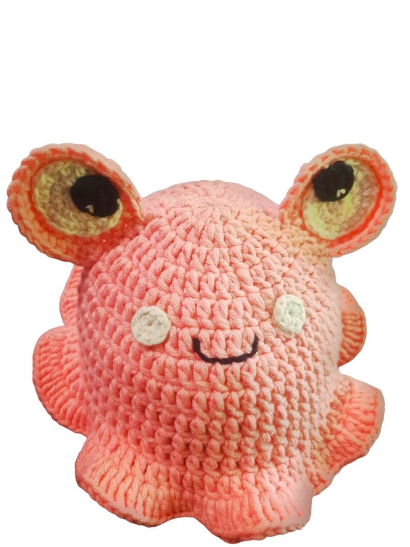 Crochet Pink Frog Bucket Hat (Category: Hats & Beanies) located in Pasig City. Submitted by ohdeepee13 (Listing ID 1466476797, Image 1). Description: 📦 Ready to ship 👒Free size - Handmade crochet bucket hat in soft pastel pink - Features cute 3D frog eyes, white cheek circles, and a stitched smiley mouth - Flared wavy brim style for a trendy look - Made from soft, lightweight, and stretchy yarn for a comfortable fit - Clean stitches and crafted