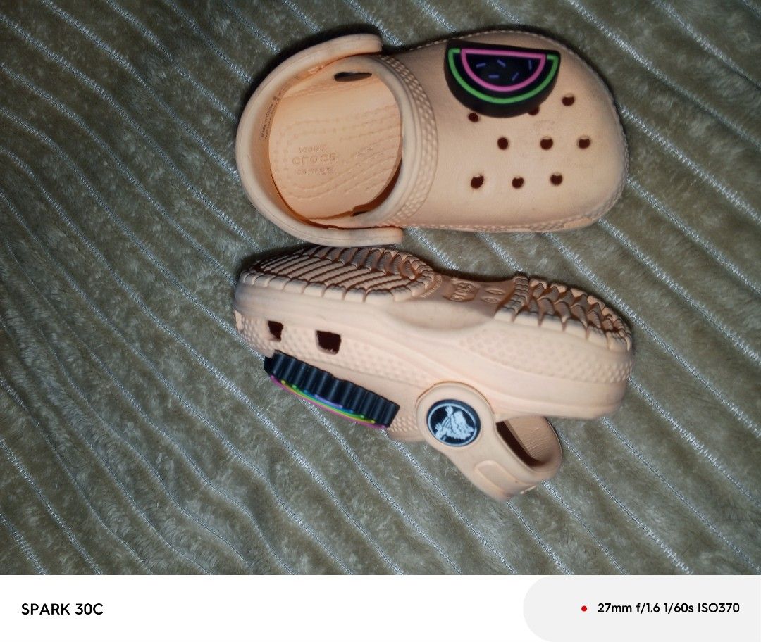 Crocs Classic Clogs Kids Size C4 Peach With Jibbitz (Category: Babies & Kids Fashion) located in Muntinlupa City. Submitted by bravedolphin.c112ad (Listing ID 1466428932, Image 3). Description: - Size: Toddler C4 - Color: Peach - Includes attached Jibbitz: Pineapple, watermelon, rainbow, peace sign - Features: Slip-on design with secure pivoting heel strap and Iconic Crocs comfort insoles - Condition: Light dirt on soles from previous wear, other