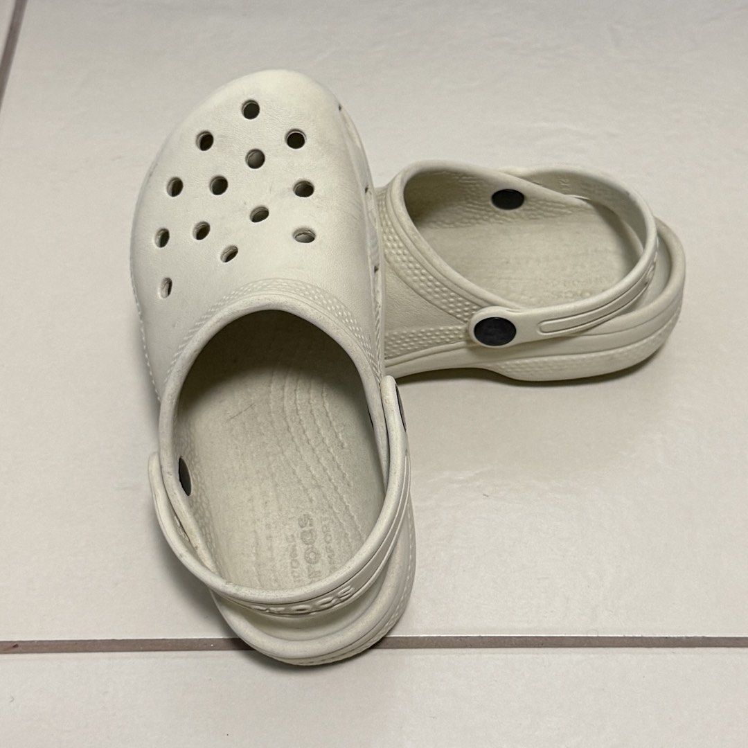 Crocs Classic Clogs Off White Size C12 (Category: Babies & Kids Fashion) located in Taguig. Submitted by lessthangel_ (Listing ID 1465224232, Image 3). Description: - Item: Crocs Classic Clogs - Color: Bone / Off-White - Size: C12 (Kids) - Design: Slip-on with ventilation ports and pivoting heel strap - Condition: Pre-loved with moderate scuffs and dirt marks from daily wear - Perfect for daily casual wear, playground, or beach trips -Not thrifte