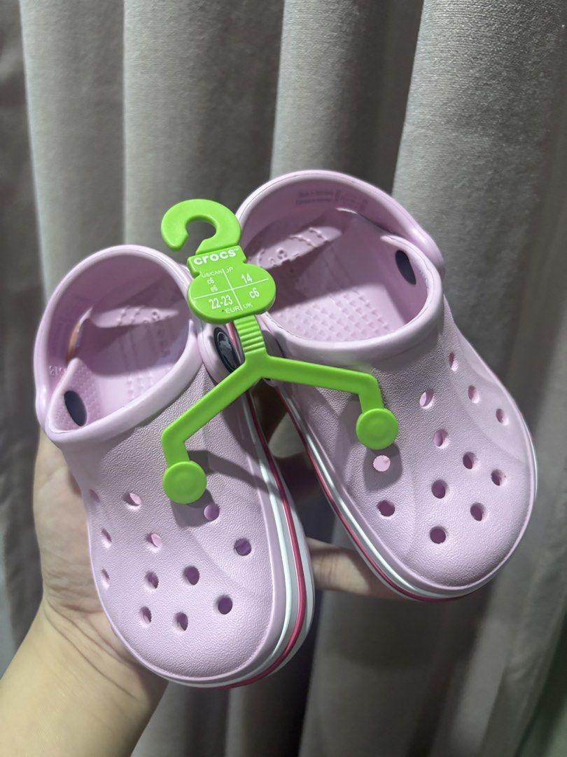 Crocs Clog Toddler Size C6 Pink (Category: Babies & Kids Fashion) located in San Mateo. Submitted by f8e3sj (Listing ID 1466489246, Image 1). Description: - Brand new, never worn - Pink Crocs Baya Band Clog for toddlers - Size: C6 (EUR 22-23, 130mm) - Lightweight slip-on design - Comes in original plastic packaging with hanger attached.