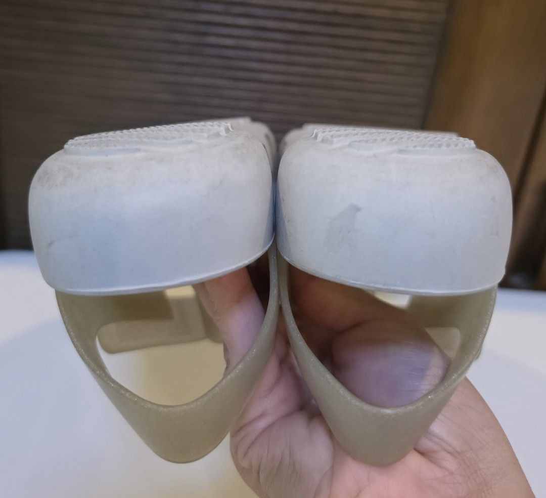 Crocs Jelly Sandals White Size 13 (Category: Babies & Kids Fashion) located in San Fernando. Submitted by iris_dj23 (Listing ID 1466359699, Image 3). Description: - Color/Style: Translucent glitter white jelly sandals - Size: 13 (printed on outsole) - Features: Adjustable ankle strap, cutout strap design, and textured footbed - Condition: Soles show light wear from normal use - Perfect for casual wear and easy to clean.