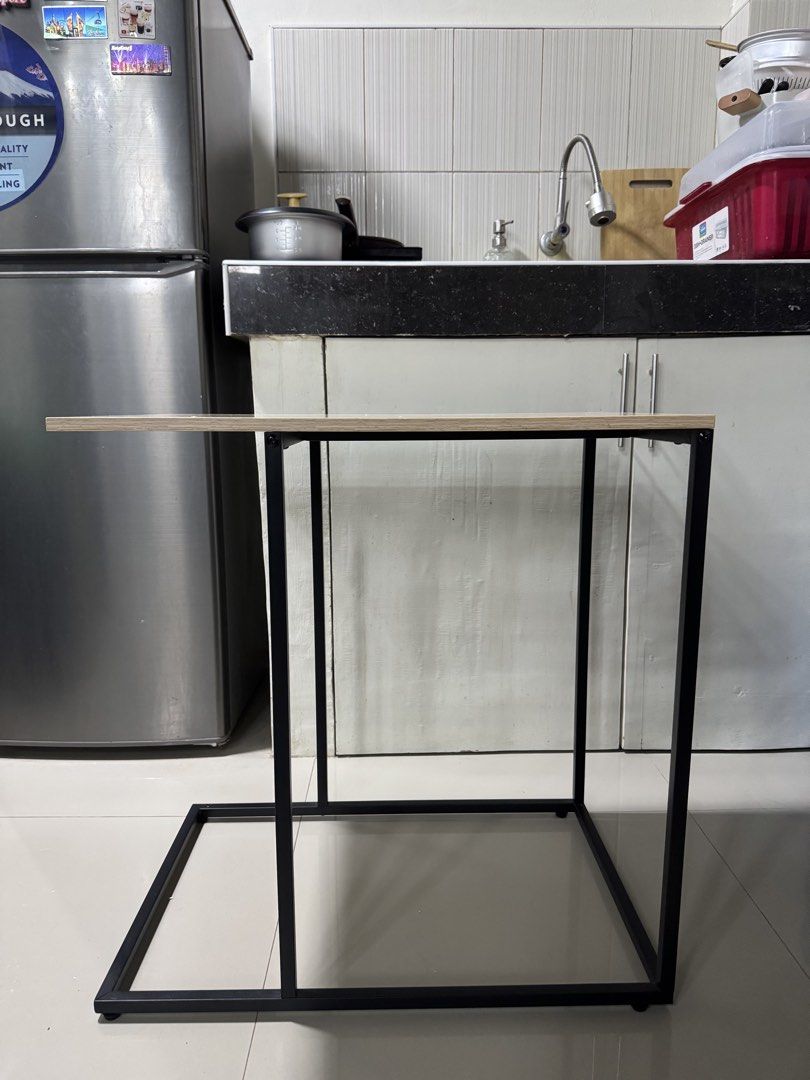side table (Category: Tables & Sets) located in Cagayan de Oro. Submitted by serenexsienna (Listing ID 1466458109, Image 2). Description: ✅C-shaped side table with wood top and metal frame ✅Beside your sofa or bed ✅Stylish light wood grain top with a sturdy black metal base ✅Clean and minimal look, perfect for small spaces ✅Ideal for display, working on your laptop or enjoying snacks.