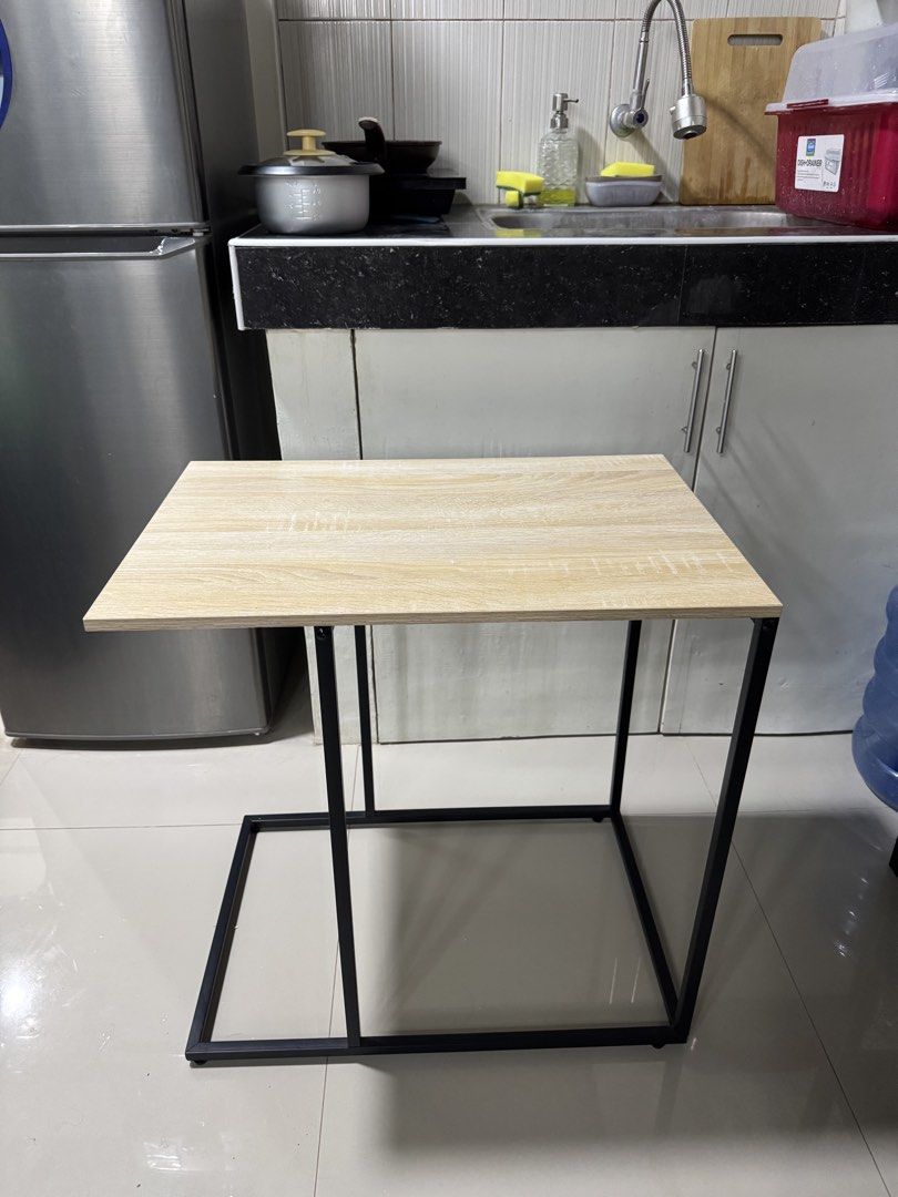 side table (Category: Tables & Sets) located in Cagayan de Oro. Submitted by serenexsienna (Listing ID 1466458109, Image 1). Description: ✅C-shaped side table with wood top and metal frame ✅Beside your sofa or bed ✅Stylish light wood grain top with a sturdy black metal base ✅Clean and minimal look, perfect for small spaces ✅Ideal for display, working on your laptop or enjoying snacks.