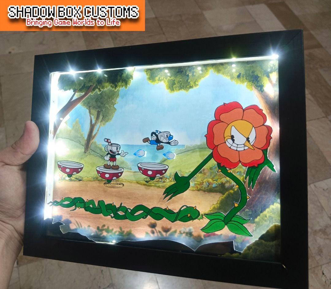 Cuphead Vs Cagney Carnation Video Game Shadow Box (Category: Nintendo) located in Quezon City. Submitted by natzuki10 (Listing ID 1466362670, Image 2). Description: Cuphead Vs Cagney Carnation Video Game Shadow Box Height: 8 inches Width: 10 inches 750 w/o lights 920 w/ lights *Handmade Pixel Shadow Boxes *Accepting Customized Designs *Perfect for Gamers & Collectors #videogames #nintendo #playstation #roomdecor #collection #gamer #gift.