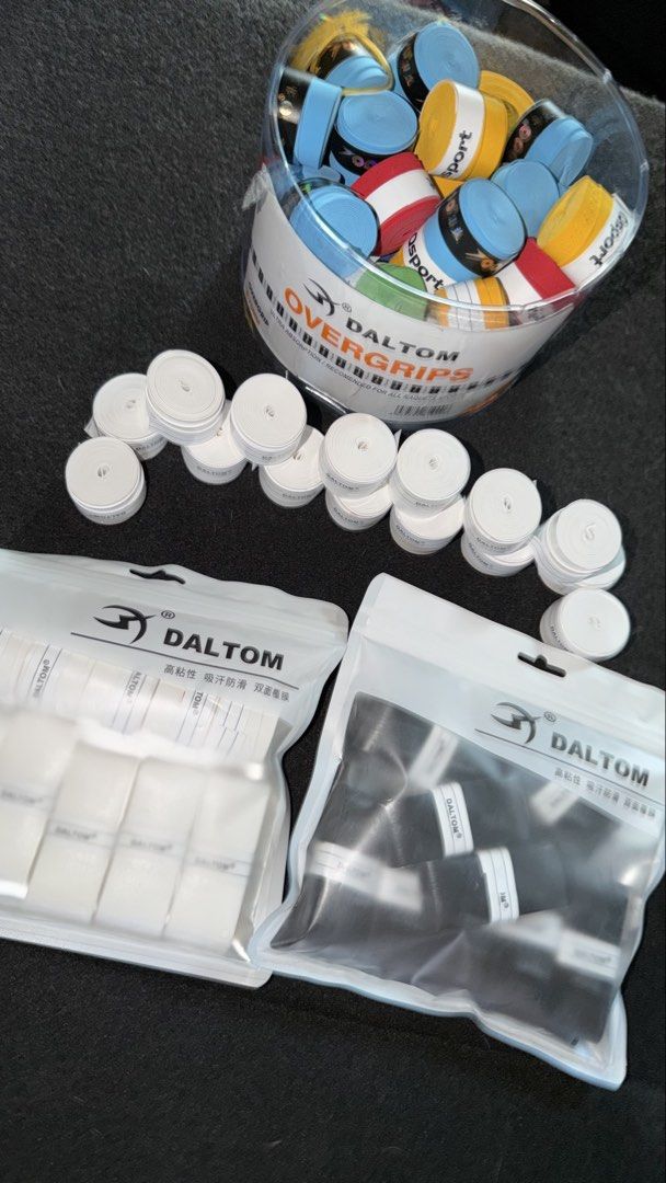 Daltom Overgrips & Clear Edge Tape (Category: Racket and Ball Sports) located in Manila. Submitted by sneakspxxks (Listing ID 1466403340, Image 1). Description: - Brand: Daltom overgrips in bulk - Inclusion: 1 bucket of mixed colors + 2 sealed bags (black and white) - Sports: Suitable for tennis, badminton, and squash racquets - Features: Super tacky feel and high sweat absorption - Condition: Brand new, great for stocking up.