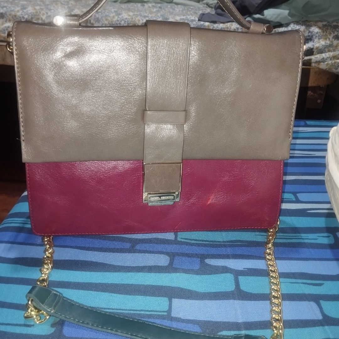 Daniel Hechter Two-Tone Shoulder Bag (Category: Shoulder Bags) located in Manila. Submitted by lene48 (Listing ID 1466364016, Image 2). Description: - Brand: Daniel Hechter - Style: Colorblock shoulder bag (Taupe and Maroon) - Strap: Gold-tone chain with dark green leather comfort section - Hardware: Rectangular metallic clasp with engraved branding & rear zipper pocket - Interior: Structured multi-compartment with neat edge stitching - Condition