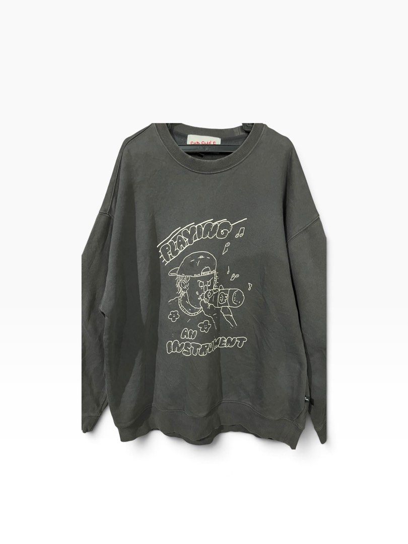 Dark Grey Graphic Sweatshirt Playing An Instrument (Category: Coats, Jackets and Outerwear) located in Manila. Submitted by matik6 (Listing ID 1466542304, Image 1). Description: Dark grey crewneck sweatshirt with oversized fit. Graphic print on the chest reads PLAYING AN INSTRUMENT with a character drinking. Ribbed collar, cuffs, and hem. Clean back with no prints. Super comfy casual wear for everyday hanging out..