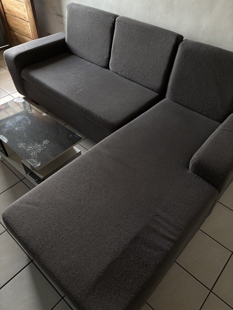Dark Grey L-Shaped Sectional Sofa (Category: Sofas) located in Manila. Submitted by m1kkoo (Listing ID 1466344520, Image 1). Description: - Color: Dark grey - Type: Sectional sofa with chaise lounge - Material: Comfortable textured upholstery - Design: Clean lines with sturdy armrests - Logistics: Pickup only.