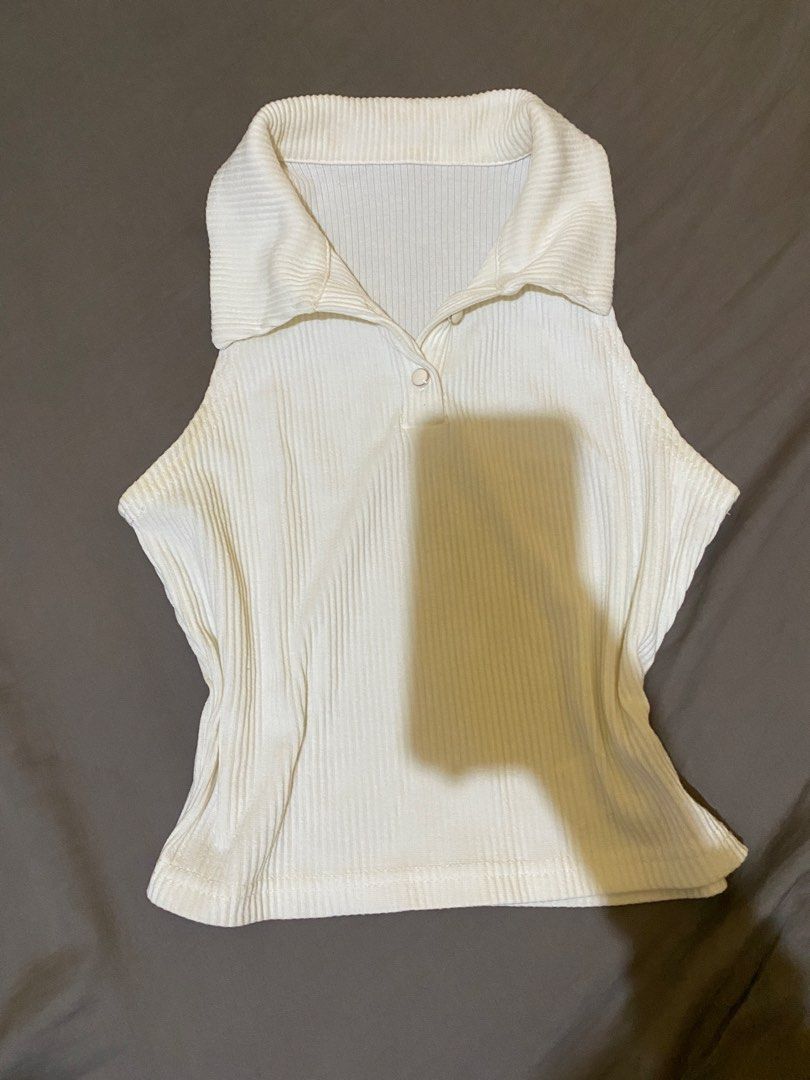 Dazy White Ribbed Polo Tank Top Size M (Category: Sleeveless) located in Abucay. Submitted by mawimawmaw (Listing ID 1466432048, Image 2). Description: - Brand: Dazy - Size: M (tag attached) - Color: White - Material: Soft and stretchy knit (polyester, viscose, and elastane) - Features: Collared neckline with single button placket, fitted silhouette - Condition: Brand new - Styling tip: Perfect to pair with high-waisted jeans or skirts.