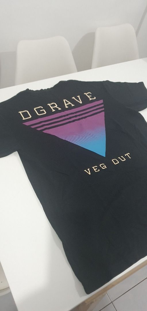 Dgrave Veg Out Black T-Shirt Medium (Category: Tshirts & Polo Shirts ) located in Quezon City. Submitted by sk8ter13 (Listing ID 1466440201, Image 2). Description: Black t-shirt from Dgrave with 'Veg Out' text graphic and a retro purple-to-blue gradient triangle design on the back. Size medium printed inside the collar. Standard crew neck style. Comfortable cotton material, easy to match with daily casual outfits..