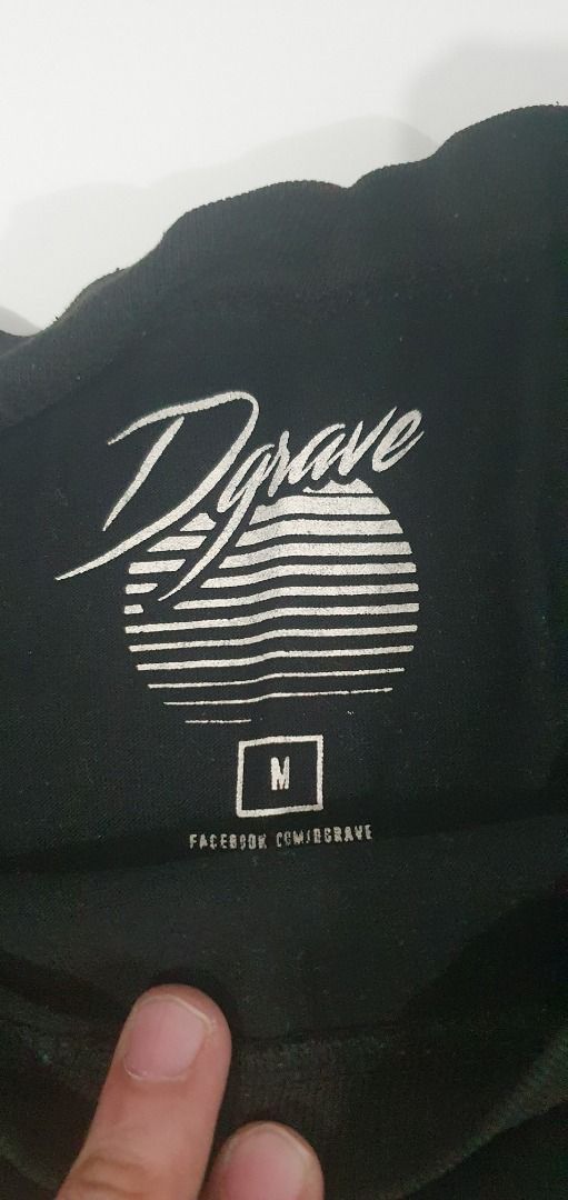 Dgrave Veg Out Black T-Shirt Medium (Category: Tshirts & Polo Shirts ) located in Quezon City. Submitted by sk8ter13 (Listing ID 1466440201, Image 1). Description: Black t-shirt from Dgrave with 'Veg Out' text graphic and a retro purple-to-blue gradient triangle design on the back. Size medium printed inside the collar. Standard crew neck style. Comfortable cotton material, easy to match with daily casual outfits..