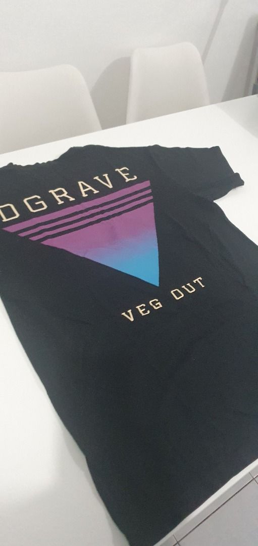Dgrave Veg Out Black T-Shirt Medium (Category: Tshirts & Polo Shirts ) located in Quezon City. Submitted by sk8ter13 (Listing ID 1466440201, Image 3). Description: Black t-shirt from Dgrave with 'Veg Out' text graphic and a retro purple-to-blue gradient triangle design on the back. Size medium printed inside the collar. Standard crew neck style. Comfortable cotton material, easy to match with daily casual outfits..