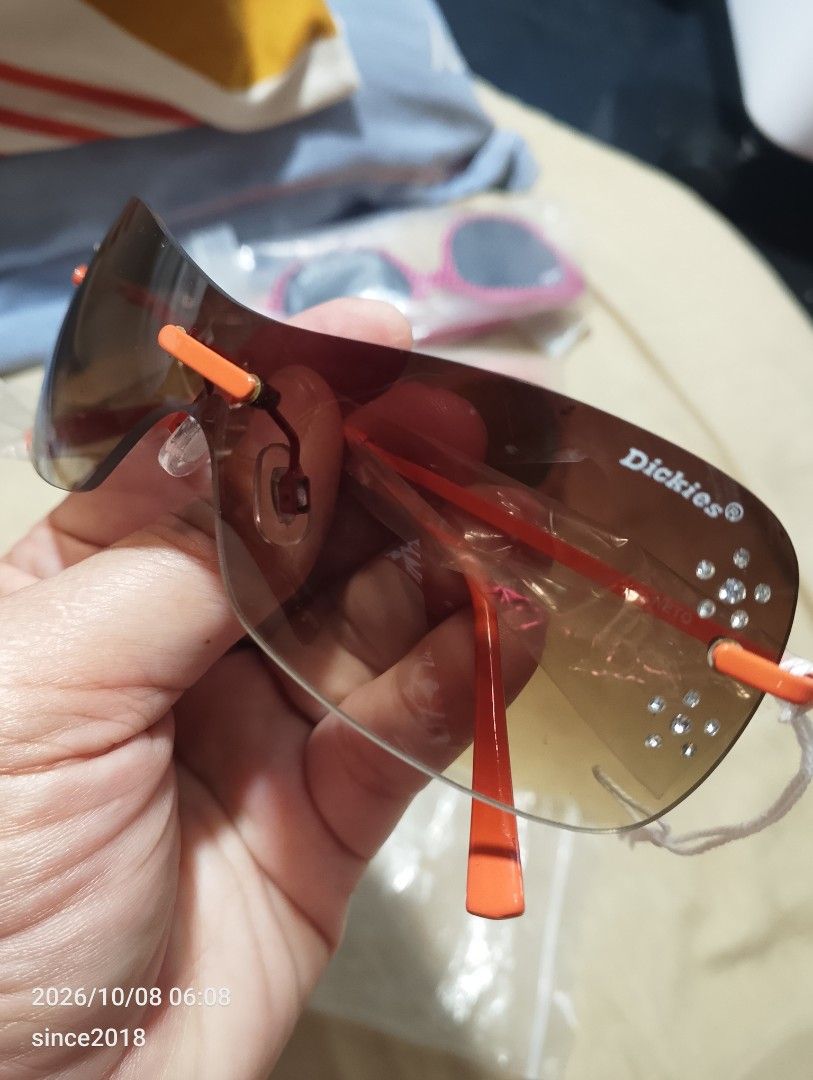 Dickies Eyewear Brown Shield Sunglasses with Crystals (Category: Sunglasses & Eyewear) located in Quezon City. Submitted by sellingwithlove2018 (Listing ID 1466561725, Image 2). Description: - Brand: Dickies - Lens: Brown gradient shield with branded logo - Accents: Bright orange arms and nose pads with small rhinestone crystals near the temples - Details: Signature logo on the arm, one arm still has original protective plastic wrapping -No case 