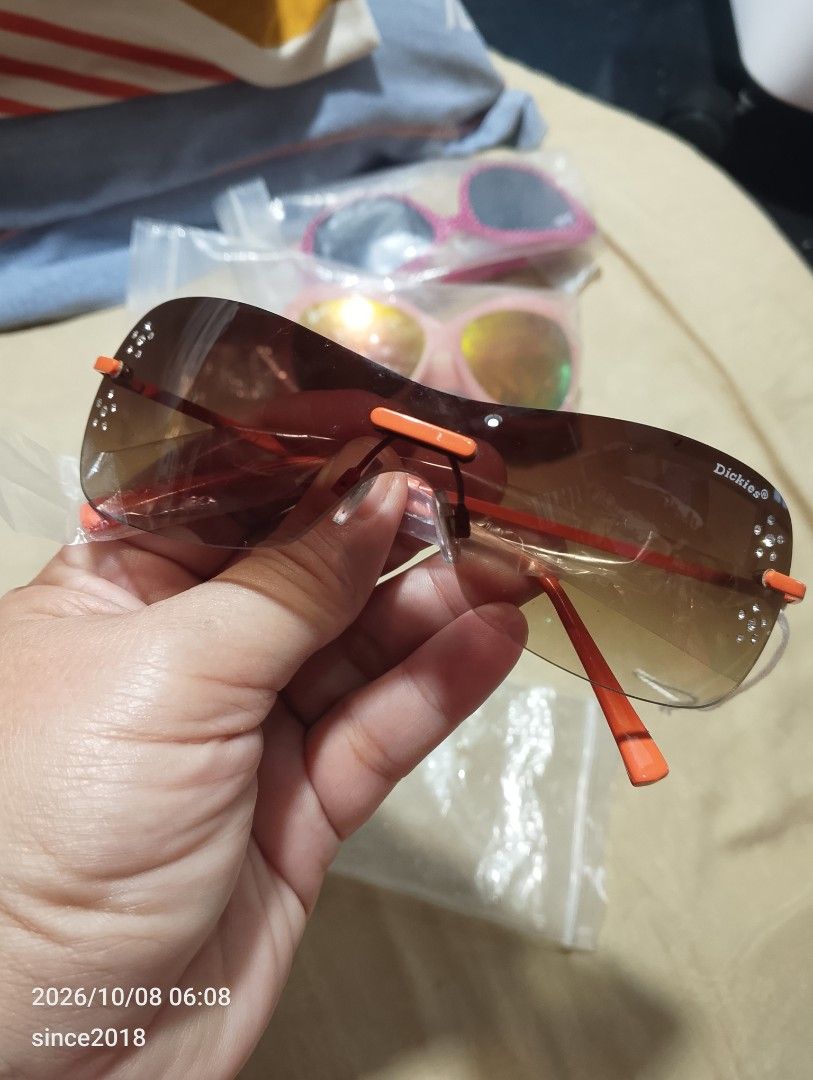 Dickies Eyewear Brown Shield Sunglasses with Crystals (Category: Sunglasses & Eyewear) located in Quezon City. Submitted by sellingwithlove2018 (Listing ID 1466561725, Image 1). Description: - Brand: Dickies - Lens: Brown gradient shield with branded logo - Accents: Bright orange arms and nose pads with small rhinestone crystals near the temples - Details: Signature logo on the arm, one arm still has original protective plastic wrapping -No case 