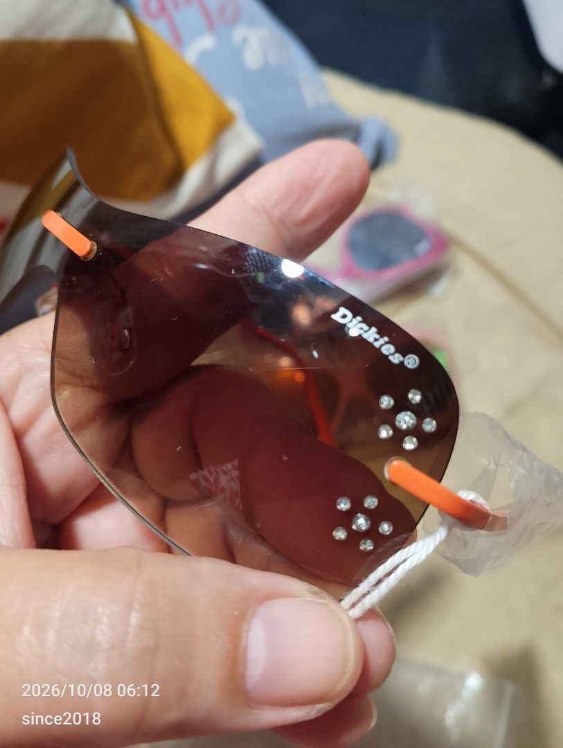 Dickies Eyewear Brown Shield Sunglasses with Crystals (Category: Sunglasses & Eyewear) located in Quezon City. Submitted by sellingwithlove2018 (Listing ID 1466561725, Image 3). Description: - Brand: Dickies - Lens: Brown gradient shield with branded logo - Accents: Bright orange arms and nose pads with small rhinestone crystals near the temples - Details: Signature logo on the arm, one arm still has original protective plastic wrapping -No case 