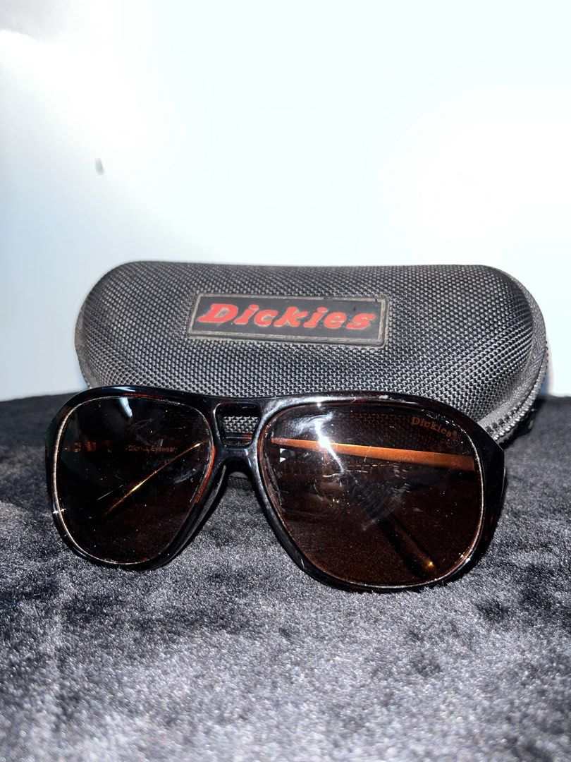Dickies Eyewear Rohan Sunglasses with Hard Case (Category: Sunglasses & Eyewear) located in Baguio. Submitted by azcollections_scar (Listing ID 1466384259, Image 2). Description: - Brand: Dickies Eyewear (Model: Rohan) - Frame: Tortoiseshell style with metal temples and stamped Dickies logo - Lenses: Dark brown with original branding - Inclusion: Matching black Dickies hard zip case with red rubber logo patch - Condition: Excellent, well-maintain