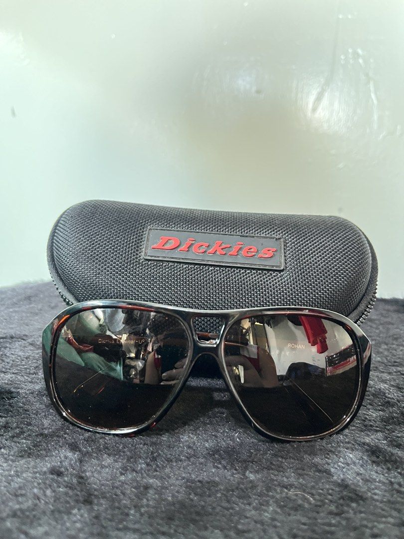 Dickies Eyewear Rohan Sunglasses with Hard Case (Category: Sunglasses & Eyewear) located in Baguio. Submitted by azcollections_scar (Listing ID 1466384259, Image 1). Description: - Brand: Dickies Eyewear (Model: Rohan) - Frame: Tortoiseshell style with metal temples and stamped Dickies logo - Lenses: Dark brown with original branding - Inclusion: Matching black Dickies hard zip case with red rubber logo patch - Condition: Excellent, well-maintain