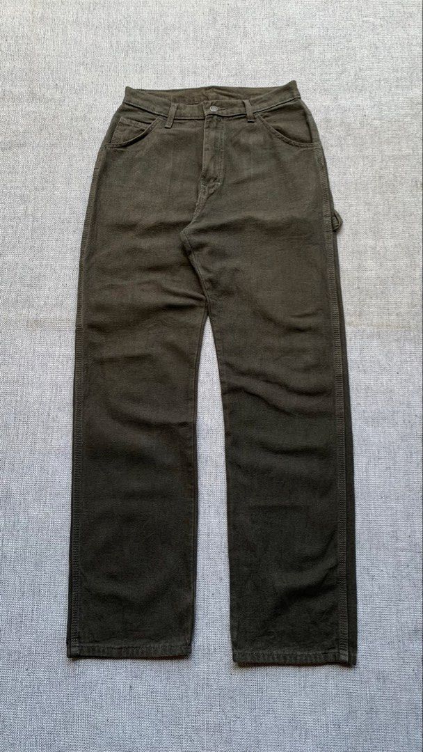 Dickies Olive Green Cargo Pants (Category: Trousers) located in Jamindan. Submitted by darinville30528 (Listing ID 1466415031, Image 3). Description: - Brand: Dickies - Style: Utility carpenter pants with relaxed straight leg - Color: Dark olive green - Material: Durable, heavy-duty canvas fabric - Features: Multiple tool pockets, side hammer loop, and metal button fly closure - Branding: Classic red and yellow Dickies logo patch on the back pock