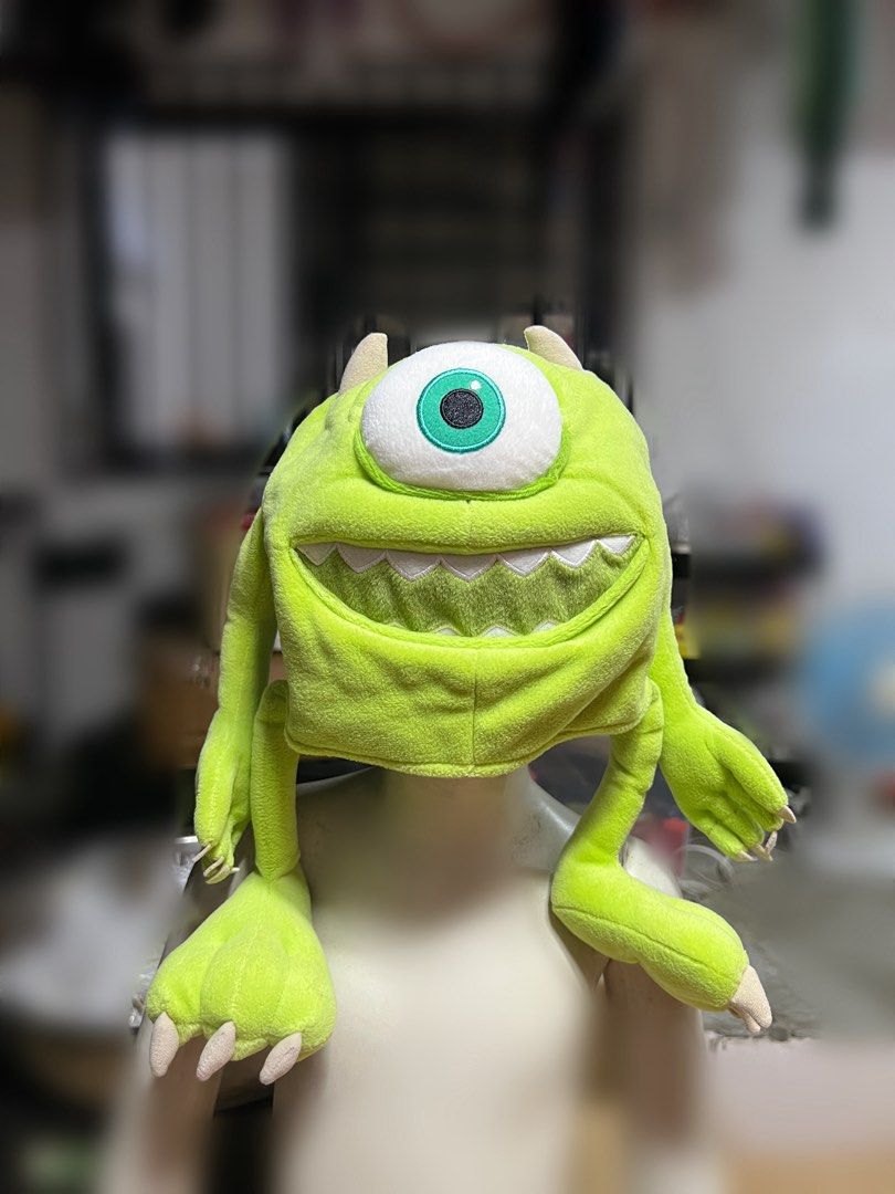 Disney Pixar Monsters Inc Mike Wazowski Hat (Category: Plushies & Soft Toys) located in Rizal. Submitted by kate_declutterr (Listing ID 1466477326, Image 1). Description: - Authentic Monsters Inc. Mike Wazowski plush hat - Made from soft, bright green fleece material - Features a large embroidered single eye and wide smiling teeth - Detailed with cute little horns on top and playful dangling arms and legs - Soft and cozy fit, ideal for costumes, 