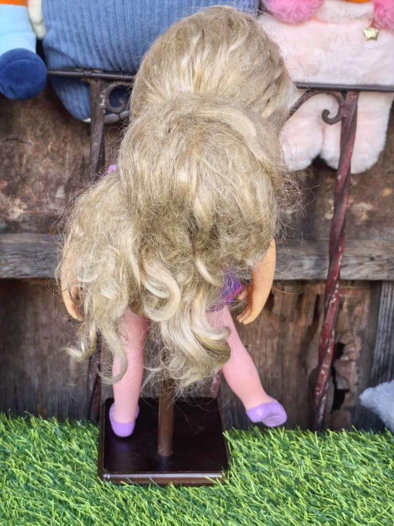 Disney Rapunzel Doll Jakks Pacific (Category: Kids Toys) located in Paranaque City. Submitted by furugiyafinds (Listing ID 1466351518, Image 3). Description: - Authentic Disney Rapunzel doll by Jakks Pacific - Wears her classic purple and pink dress - Features lovely blonde hair, green eyes, and cute freckles - Includes a brown display stand as seen in photos - Great addition for Disney fans and collectors - Condition: Excellent / Well-kept - Mod