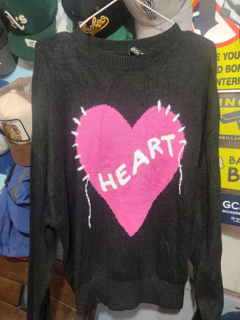 Divided Black Sweater with Pink Heart Graphic (Category: Longsleeves) located in Manila. Submitted by momofunodos (Listing ID 1460198780, Image 2). Description: ALL ITEMS ARE PRE-LOVED ✅Bale source. ✅Ukay thrifted. ✅Manage your expectations these are ukay.( dont expect crispy as new) ✅ Colors may different in person due to camera lens and lights. ✅ There's a sign of usage in every item ✅ Small stain washable stain are normal in ukay we do not con