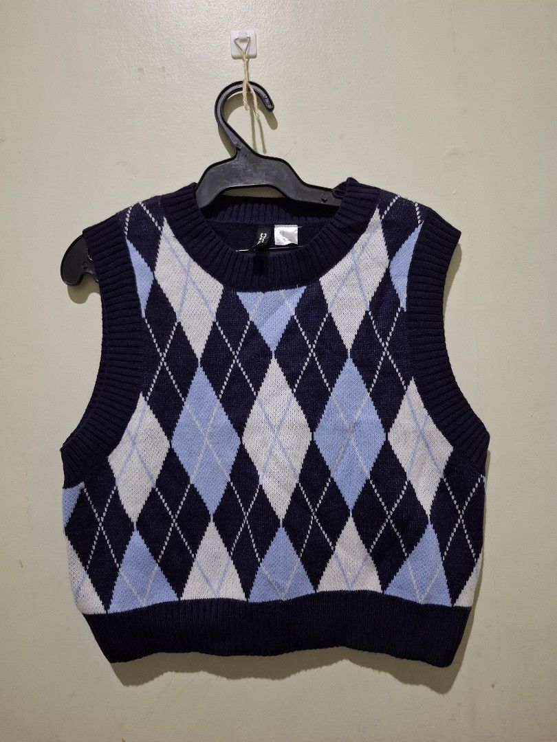 Divided H&M Argyle Knit Sweater Vest Size S (Category: Vests) located in Tuguegarao City. Submitted by potaetonim (Listing ID 1466483947, Image 1). Description: - Brand/Model: Divided by H&M argyle knit sweater vest - Color: Navy blue base with light blue and white diamond pattern - Details: Classic crew neck, ribbed hem, great layering piece - Size: Small - Material: 100% acrylic - Condition: Clean and well-maintained overall.