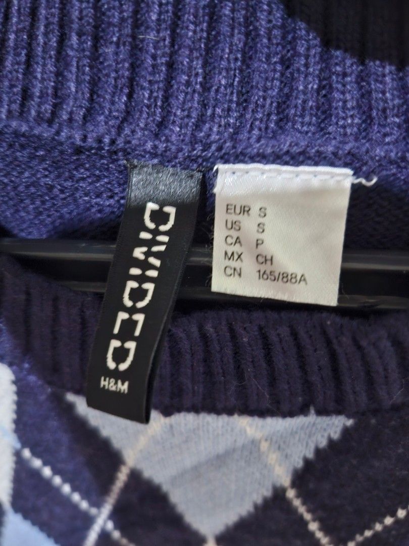 Divided H&M Argyle Knit Sweater Vest Size S (Category: Vests) located in Tuguegarao City. Submitted by potaetonim (Listing ID 1466483947, Image 3). Description: - Brand/Model: Divided by H&M argyle knit sweater vest - Color: Navy blue base with light blue and white diamond pattern - Details: Classic crew neck, ribbed hem, great layering piece - Size: Small - Material: 100% acrylic - Condition: Clean and well-maintained overall.