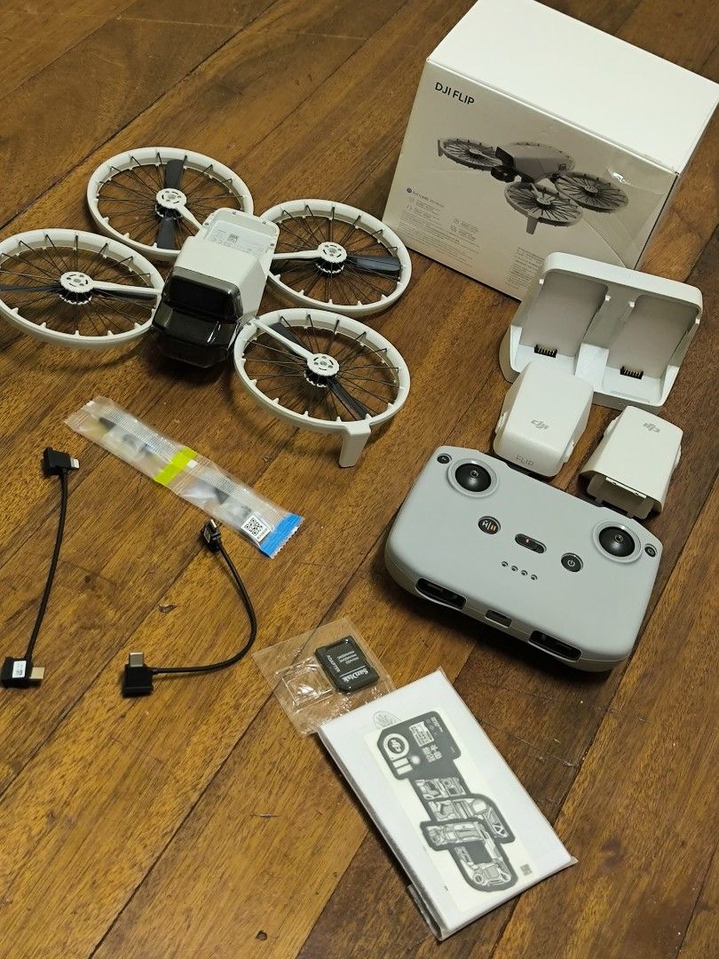DJI Flip Drone rush sale (Category: Drones) located in Pasay City. Submitted by morricemorrice (Listing ID 1466479911, Image 3). Description: - DJI drone setup, ready for flight and in pristine condition with zero scratches - Includes grey remote controller and two white flight batteries - Comes with a multi-battery charging dock and spare propellers - Packed in its original retail box.