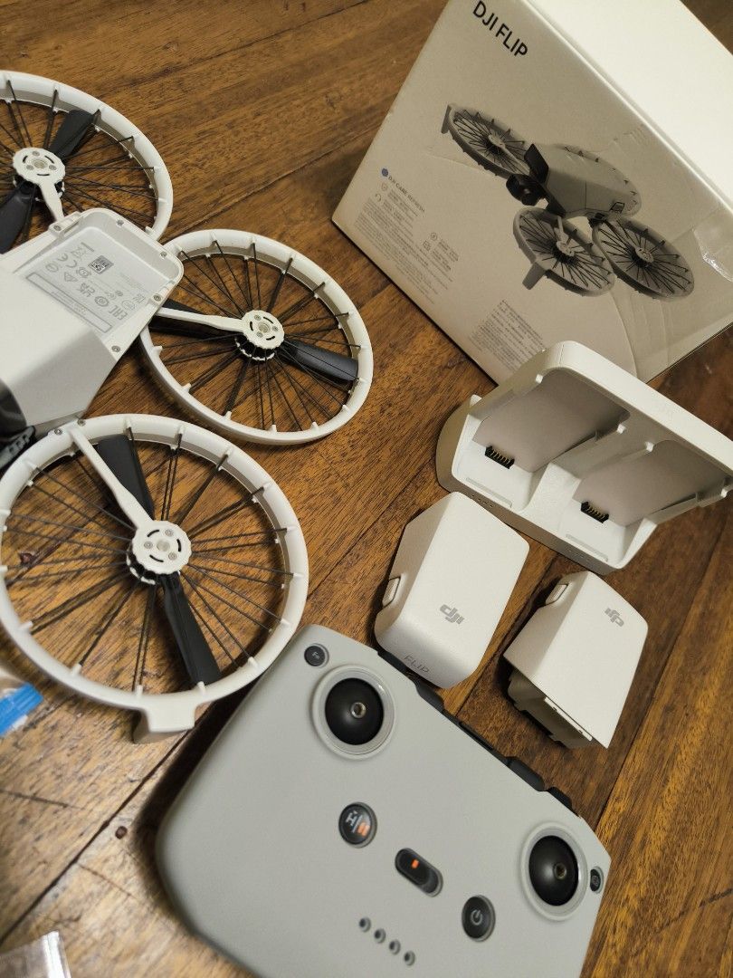 DJI Flip Drone rush sale (Category: Drones) located in Pasay City. Submitted by morricemorrice (Listing ID 1466479911, Image 1). Description: - DJI drone setup, ready for flight and in pristine condition with zero scratches - Includes grey remote controller and two white flight batteries - Comes with a multi-battery charging dock and spare propellers - Packed in its original retail box.