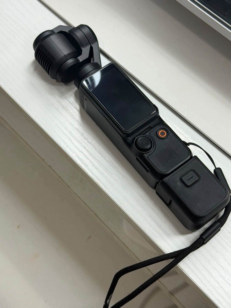 DJI Osmo Pocket 3 Gimbal Camera (Category: Cameras) located in Quezon City. Submitted by rencizuniga (Listing ID 1466358692, Image 3). Description: - Model: DJI Osmo Pocket 3 (Black) - Condition: Fully functional, clean glass and screen - Key Features: Compact 4K camera, rotating touchscreen, 3-axis mechanical gimbal stabilization - Ideal For: Vlogging and travel videography - Inclusions: Original retail box and wrist strap attached to handle PRI