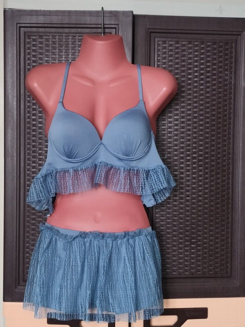 Dusty blue bikini set with cover-up (Category: Bikinis & Swimsuits) located in Las Pinas. Submitted by cozychic19 (Listing ID 1466365076, Image 1). Description: Dusty blue multi-piece swimwear set. Includes a padded bra top with underwire and ruffled hem, matching skirt-style bottoms, and a long sheer cover-up robe. Straps cross over the back. Textured mesh overlay on the ruffles and robe. Great beach or pool outfit. Issue: Snapped cross over bac