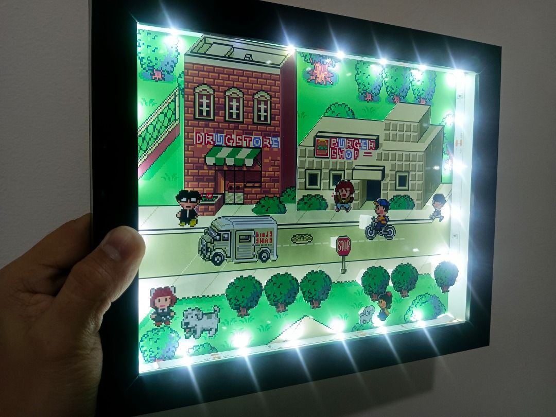 Earthbound Video Retro Game Shadow Box (Category: Nintendo) located in Quezon City. Submitted by natzuki10 (Listing ID 1466365069, Image 3). Description: Earthbound Video Retro Game Shadow Box Height: 8 inches Width: 10 inches 750 w/o lights 920 w/ lights *Handmade Pixel Shadow Boxes *Accepting Customized Designs *Perfect for Gamers & Collectors #videogames #nintendo #roomdecor #collection #gamer #gift #retrogame.