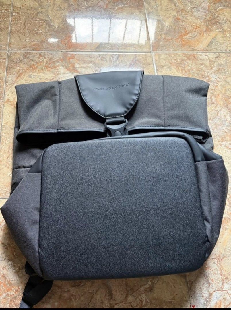 EcoFlow Power a New World Backpack (Category: Backpacks) located in Bacoor. Submitted by rachejan.gregorio.24 (Listing ID 1466383147, Image 1). Description: EcoFlow roll-top backpack in dark grey and black. Durable water-resistant material on the bottom compartment. Padded mesh shoulder straps with sternum strap and top grab handle. Main compartment expands with a roll-top closure secured by a buckle strap. Front zipped pocket and subtle branding