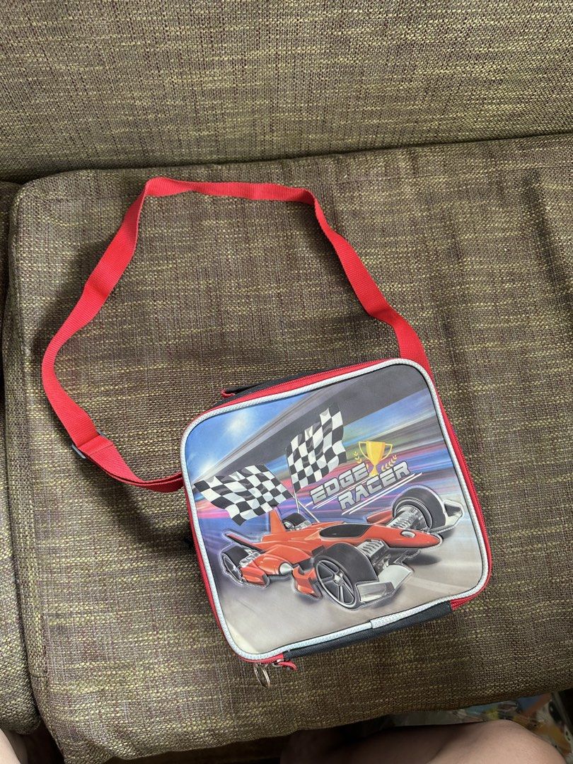 Edge Racer Kids Lunch Bag with Strap (Category: Tote Bags) located in Pasay City. Submitted by kimverlygo50697 (Listing ID 1466401001, Image 2). Description: - Edge Racer kids lunch bag with a sporty red and black racing car design - Equipped with a smooth-working zipper, top handle, and an adjustable red shoulder strap - White wipeable interior lining for easy cleaning - Features a built-in small elastic band inside to secure a bottle or utensil