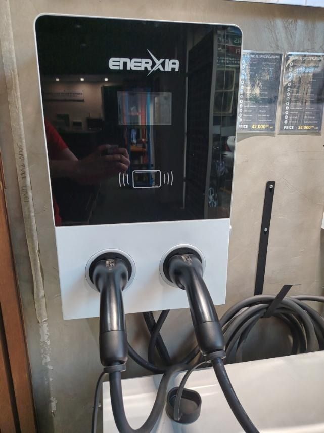 EV CHARGER OCPP READY 44KW (Category: Everything Else Others) located in Mandaluyong City. Submitted by jazhruiz (Listing ID 1466439795, Image 1). Description: - Brand: ENERXIA - Model/Type: OCPP Ready 44KW EV Charger - Design: Wall-mounted dual port system with black and white finish - Features: Integrated display screen and RFID/card reader area - Cables: Dual heavy-duty black charging cables included - Condition: Brand new, clean, and ready fo