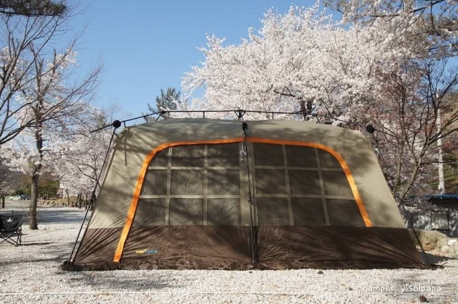 Family Camping Tent (Category: Hiking & Camping) located in Abucay. Submitted by cristineca20489 (Listing ID 1466557326, Image 1). Description: Spacious camping tent with brown and tan exterior tones. Multiple mesh window panels provide great ventilation throughout. Integrated awning creates a nice shaded outdoor seating space right at the front entrance. Heavy-duty poles and guy lines keep the whole setup completely stable on gravel or dirt grou