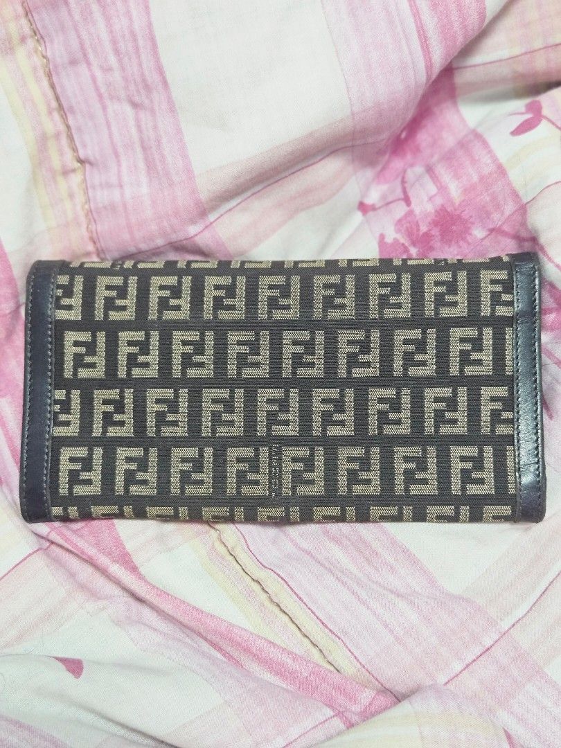 Fendi Zucchino Canvas Long Wallet (Category: Wallets & Card holders) located in Manila. Submitted by missyyyxx (Listing ID 1466458192, Image 2). Description: - Brand: Fendi - Material: Brown Zucchino canvas with dark leather trim - Hardware: Silver-tone buckle closure on front flap - Interior: Snap button closure, zipper compartment, multiple card slots, and cash compartments - Authenticity: Includes hologram authenticity tag inside pocket - Size