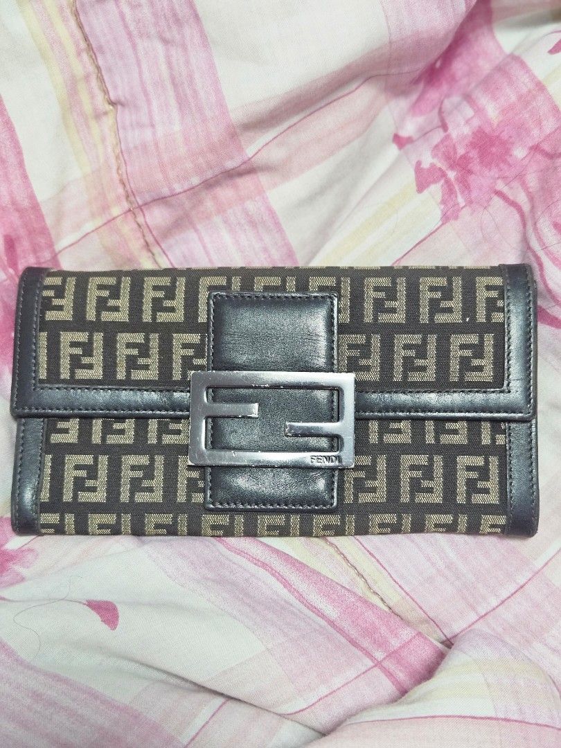 Fendi Zucchino Canvas Long Wallet (Category: Wallets & Card holders) located in Manila. Submitted by missyyyxx (Listing ID 1466458192, Image 1). Description: - Brand: Fendi - Material: Brown Zucchino canvas with dark leather trim - Hardware: Silver-tone buckle closure on front flap - Interior: Snap button closure, zipper compartment, multiple card slots, and cash compartments - Authenticity: Includes hologram authenticity tag inside pocket - Size