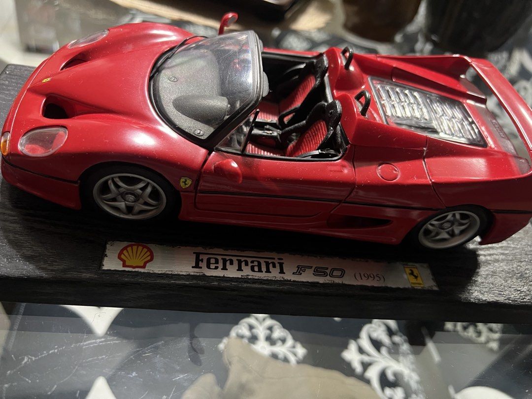 Ferrari F50 1995 Shell Collector Model Car (Category: Vehicle & Diecast Models) located in Manila. Submitted by cterrineni76861 (Listing ID 1466492042, Image 2). Description: Red Ferrari F50 model from 1995. Shell branding on the display stand base. Doors, hood, and rear engine cover all open up. Detailed interior with red and black seats. Visible engine bay detailing underneath. Mounted on a black textured wooden display plaque..