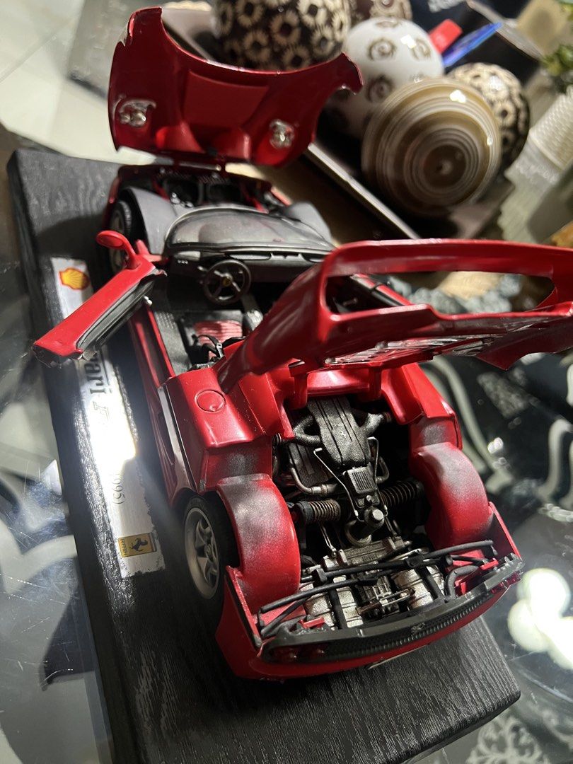 Ferrari F50 1995 Shell Collector Model Car (Category: Vehicle & Diecast Models) located in Manila. Submitted by cterrineni76861 (Listing ID 1466492042, Image 3). Description: Red Ferrari F50 model from 1995. Shell branding on the display stand base. Doors, hood, and rear engine cover all open up. Detailed interior with red and black seats. Visible engine bay detailing underneath. Mounted on a black textured wooden display plaque..