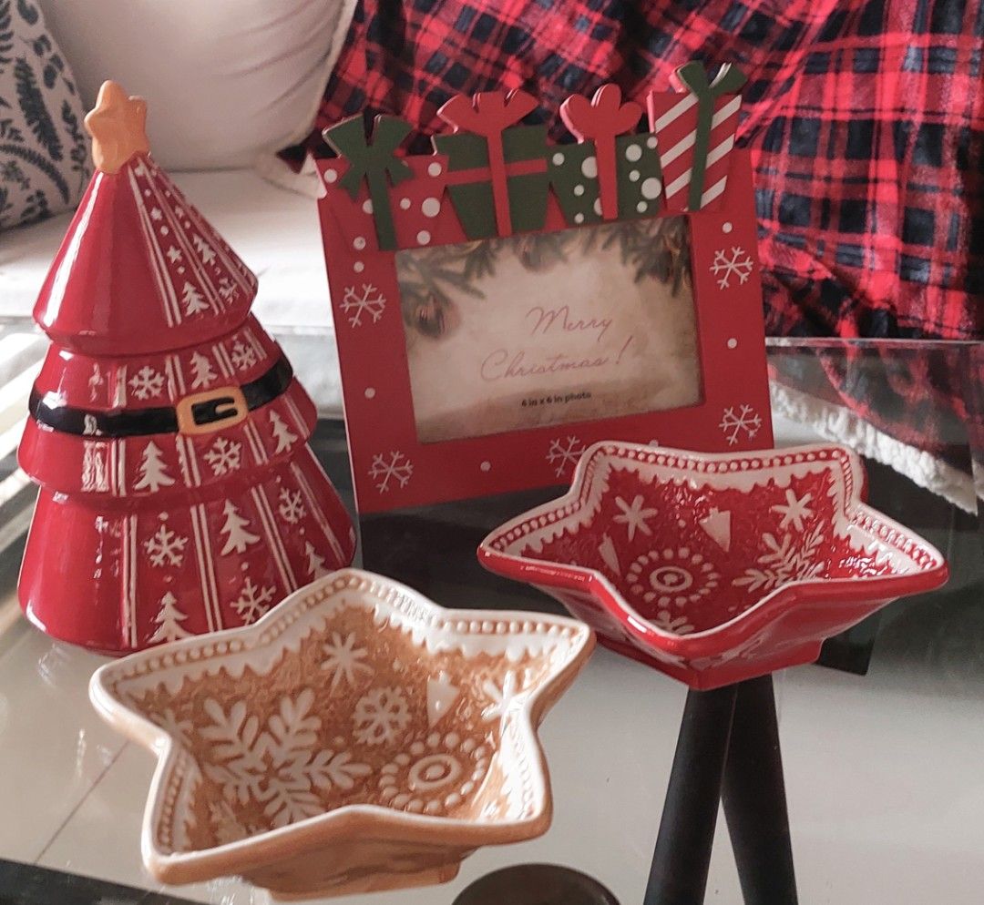 Festive Christmas Holiday Tableware Photo Frame Collection (Category: Dinnerware & Cutlery) located in Cainta. Submitted by veronica2277 (Listing ID 1466358113, Image 1). Description: Bundle of festive holiday items. Includes star-shaped snowflake bowls in red and gold, Santa suit cookie jar or treat container, Christmas tree cookie jar with star topper, plate and mug set with box, and a red wooden picture frame with gift box toppers. Cute holida