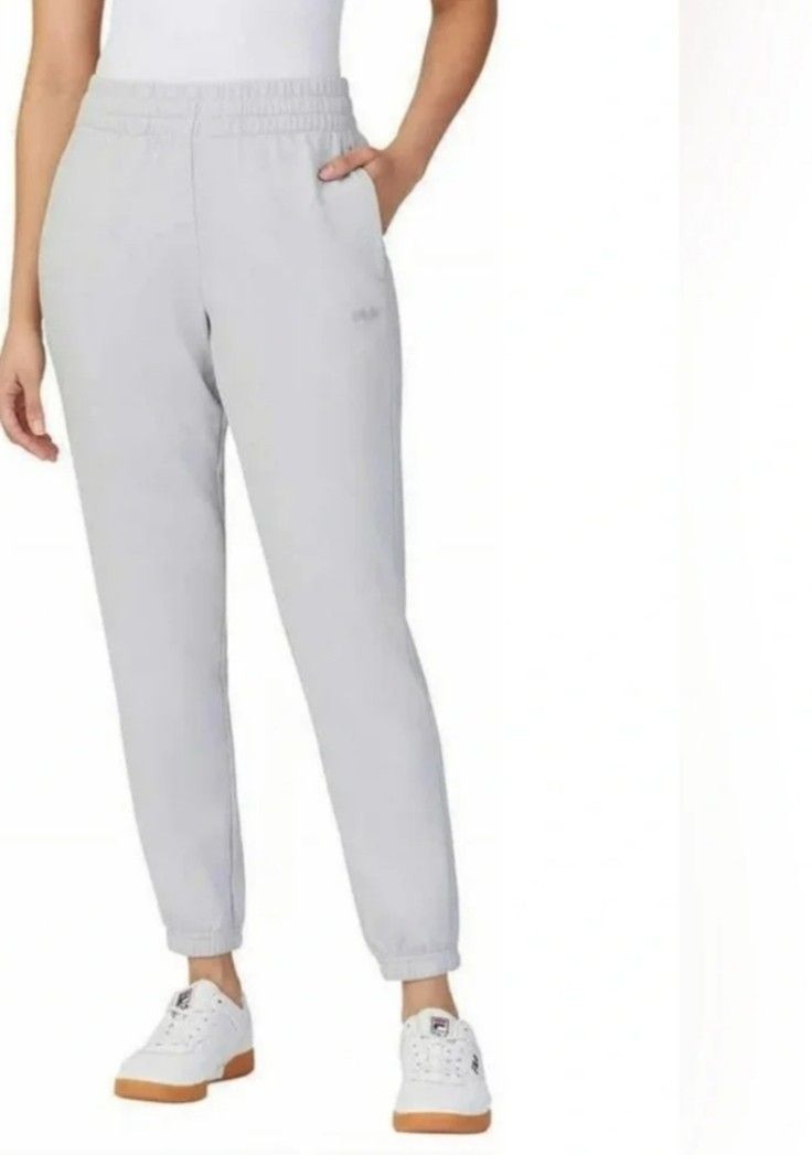 Fila grey joggers sweatpants size L (Category: Joggers) located in Manila. Submitted by lene48 (Listing ID 1466400430, Image 1). Description: - Brand: Fila - Size: Large - Color: Grey - Material: Comfortable cotton blend, made in Vietnam - Features: Elastic waistband, side pockets, and ribbed ankle cuffs - Logo: Subtle Fila logo on the left thigh - Ideal for: Everyday wear, lounging, and running errands.