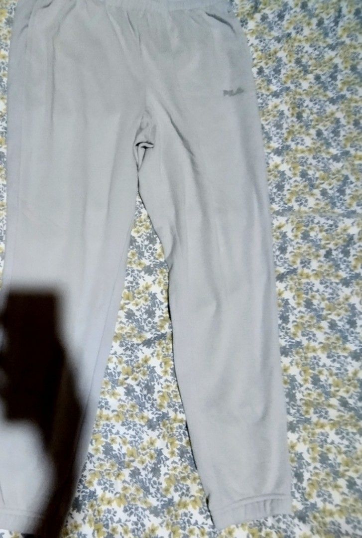 Fila grey joggers sweatpants size L (Category: Joggers) located in Manila. Submitted by lene48 (Listing ID 1466400430, Image 3). Description: - Brand: Fila - Size: Large - Color: Grey - Material: Comfortable cotton blend, made in Vietnam - Features: Elastic waistband, side pockets, and ribbed ankle cuffs - Logo: Subtle Fila logo on the left thigh - Ideal for: Everyday wear, lounging, and running errands.