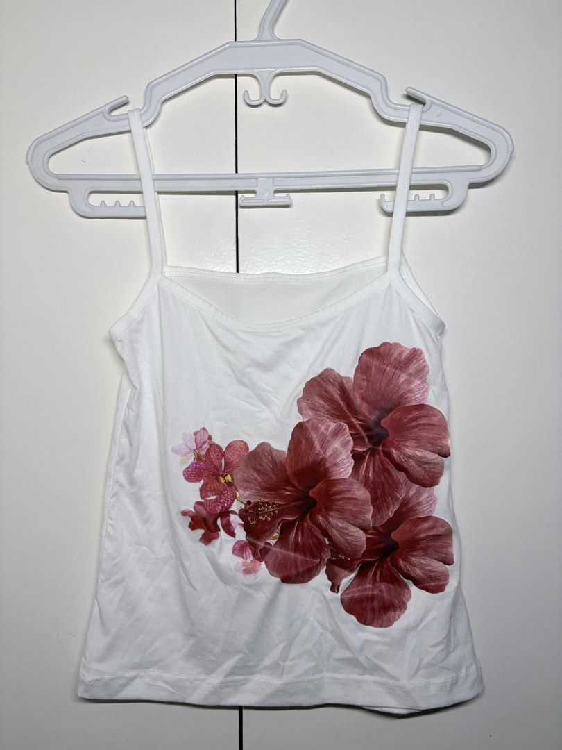 Floral Print White Cami Tank Top (Category: Sleeveless) located in Paranaque City. Submitted by honeykkkk (Listing ID 1466480757, Image 1). Description: • Details: Classic straight neck/square-style neckline, thin spaghetti straps, and a vibrant tropical hibiscus floral graphic print on the front. Clean solid white back. Lightweight, comfortable, and perfect for casual beach days or summer layering. • Condition: Excellent condition — worn once on