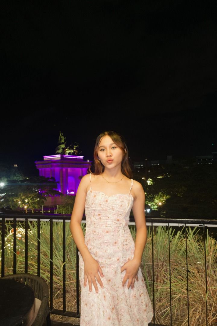 Flowy ruffle dress (Category: Dresses) located in Pasig City. Submitted by aelena._ (Listing ID 1466459193, Image 2). Description: Fits s Bust: 30-32” Waist: 25-27” Length: 48” - Color & Style: Pink midi dress with a subtle floral pattern and iridescent sheen - Neckline & Straps: Sweetheart neckline with a ruched center and delicate spaghetti straps - Details: Cascading front ruffles and a trendy asymmetrical handkerchief hemline - Fit: Body-hugg